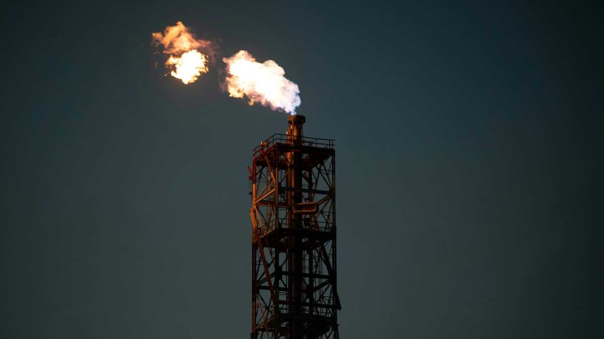Industrial gas flare at night